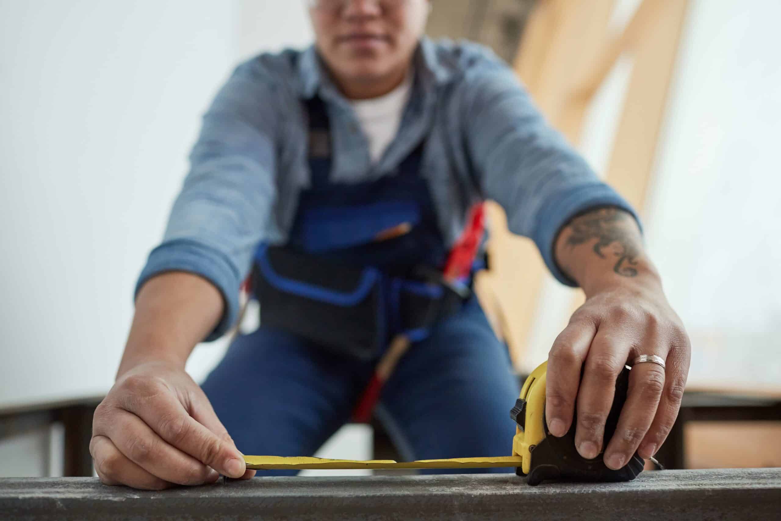 female-worker-holding-tape-measure-close-up-2023-11-27-05-31-38-utc (1)